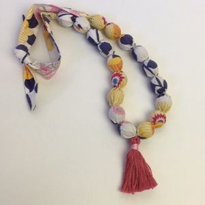 Fabric covered wooden necklace with tassel